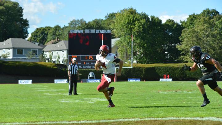 Pursued in vain by Brown's Will Twyman, Harvard quarterback Joe Viviano scampered for his second touchdown. 