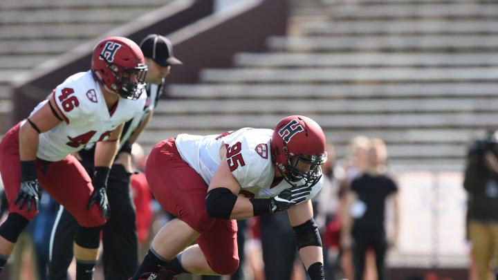 Defensive tackle Miles McCollum (95) and linebacker Sean Mackin were part of a Crimson defense that stingily held Brown to 74 net rushing yards.
