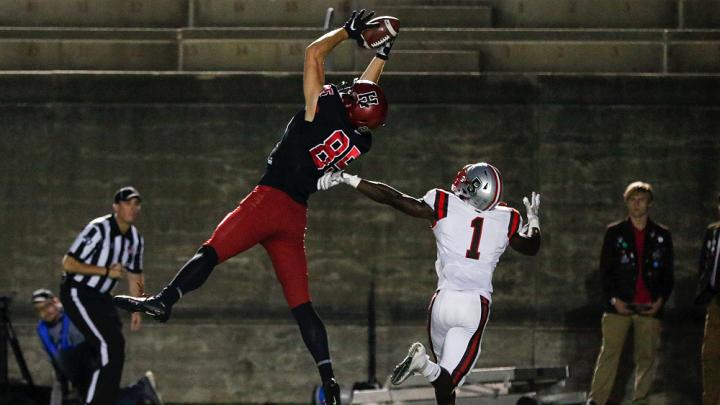 Get on up: On this scoring toss, Harvard's junior tight end Adam West was too high for Brown's BJ Ubani to handle.