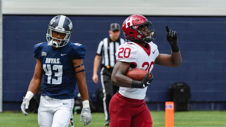 Harvard junior Aaron Shampklin (20) singed Georgetown defenders such as Jonathan Honore for 186 yards and two touchdowns.