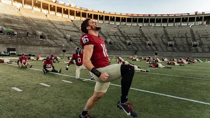 Harvard football players limbering up for season-opening game