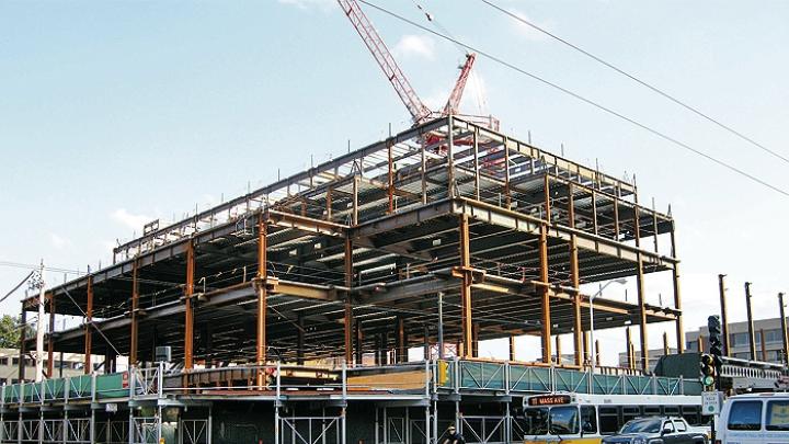 Structural steel is erected for the Law School’s Wasserstein Hall, Caspersen Student Center, and clinical-wing project on Massachusetts Avenue at Everett Street.