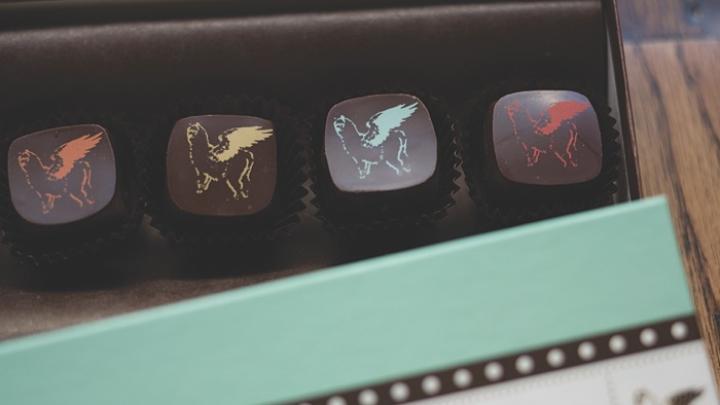 The whimsical Sôcôla logo, a winged alpaca nicknamed “Harriet,” appears in various colors on some of the truffles.