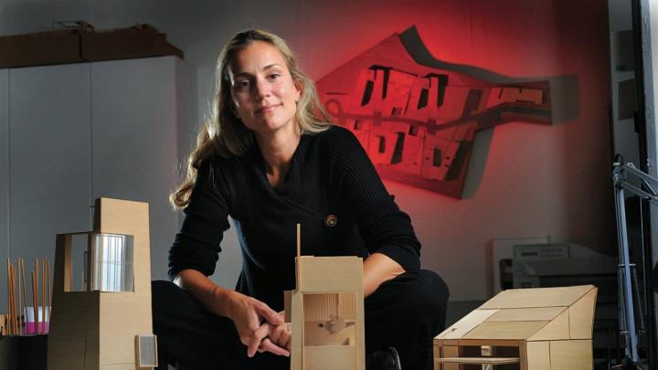 Elizabeth Whittaker, at her office in Boston, with basswood architectural models for residential and commercial structures