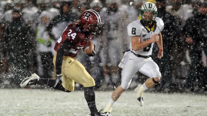With wet snow veiling the Stadium's FieldTurf surface, tailback Treavor Scales '13 had his best game of the season against Dartmouth, rushing for 139 yards and two touchdowns. Cornerback Shawn Abuhoff is the Big Green defender.