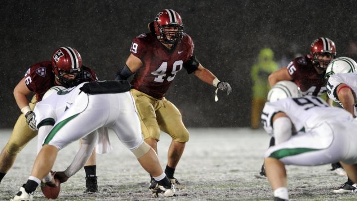 Linebacker and team captain Alex Gedeon (49) led the Crimson defense with eight tackles and a pass breakup. The other Harvard defenders are tackle Jack Dittmer (56) and linebacker Matt Martindale (45).