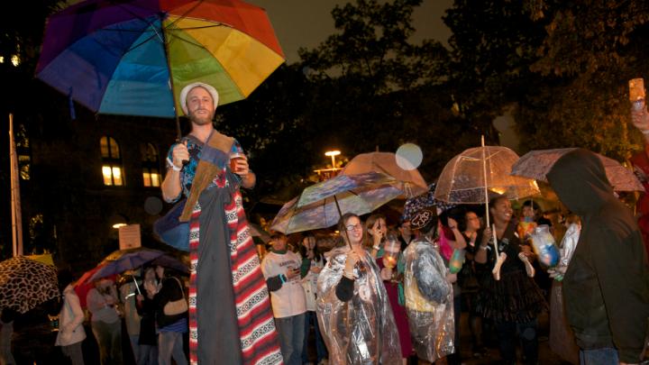 The Divinity School parade had a "pilgrimage" theme and was led by a colorful stilt walker.