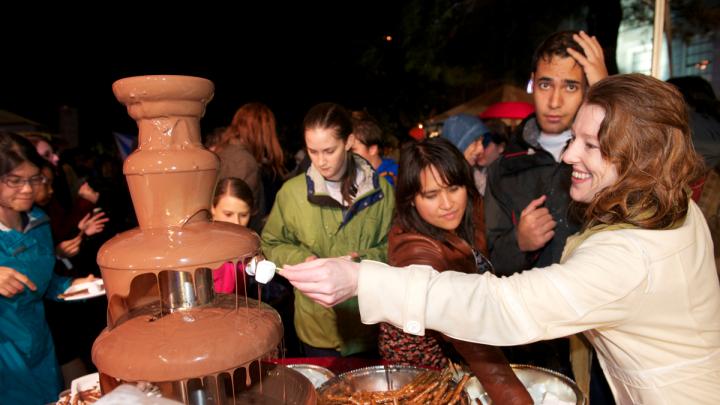 Party-goers enjoy one of two chocolate fountains. The food tents were popular as people crowded underneath to get out of the downpour.