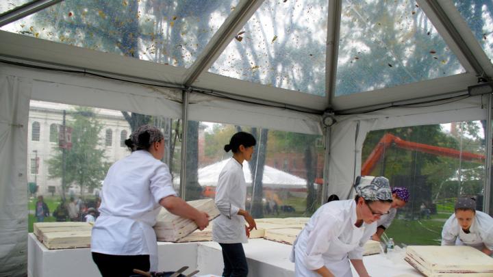 Employees unwrap and arrange the sheets as Flour owner Joanne Chang ’91 looks on.