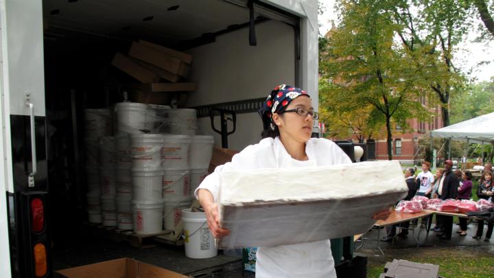 A Flour bakery employee unloads one of the layered sheet cakes.
