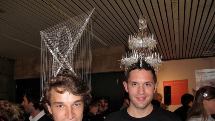 Two more Design School students show off their entries in the headdress competiton. The grand prize was an iPad 2.