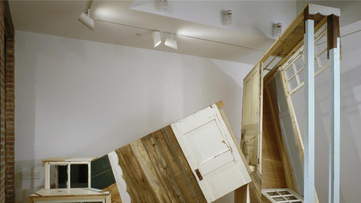 Meredith James created her 14 x 8 x 12-foot sculpture <i>Impossible House</i> with salvaged wood and windows.