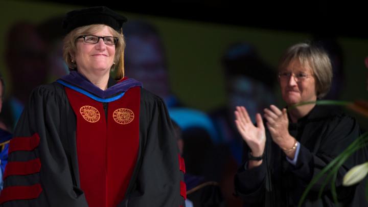Harvard president Drew Faust, right, stands as Clayton Spencer is introduced as the eighth president of Bates College on October 26, 2012.