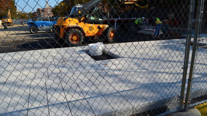 15. From the western edge of the plaza space, new surface pavers, finished with an aggregate of crushed, recycled porcelain, were being installed, with spaces for permanent seating to come during a later phase of the construction.