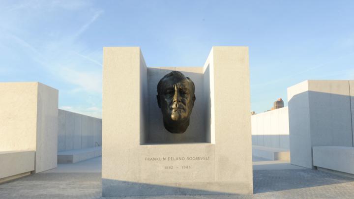 An enlarged version of the famous bronze bust of Roosevelt created by American sculptor Jo Davidson appears at the threshold of a square, white-granite, open-air plaza.