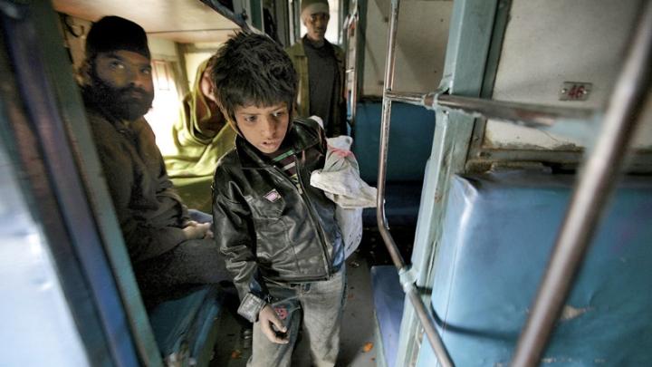 At the train station in Jaipur, India, collecting empty water bottles fetches about 100 rupees ($2) a day. Here, eight-year-old Badal searches inside a train car. 