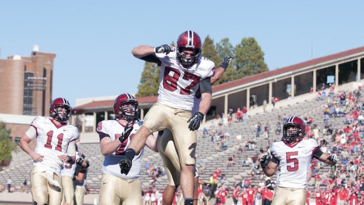 Tight end Cameron Brate (87) went airborne after catching a late-game touchdown pass that locked up the Harvard win. Behind him are quarterback Michael Pruneau (11), tackle Cole Toner (78), and wideout Ricky Zorn (5). Zorn led the Crimson receiving corps with seven catches for 64 yards. 