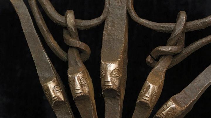 Faces appear on part of an iron axe (Zaire)