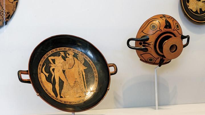 In an installation of Greek vases, drinking bowls are displayed so the decorations can be seen as they would have been when in use&mdash;both inside and out&mdash;by the drinkers and their companions.