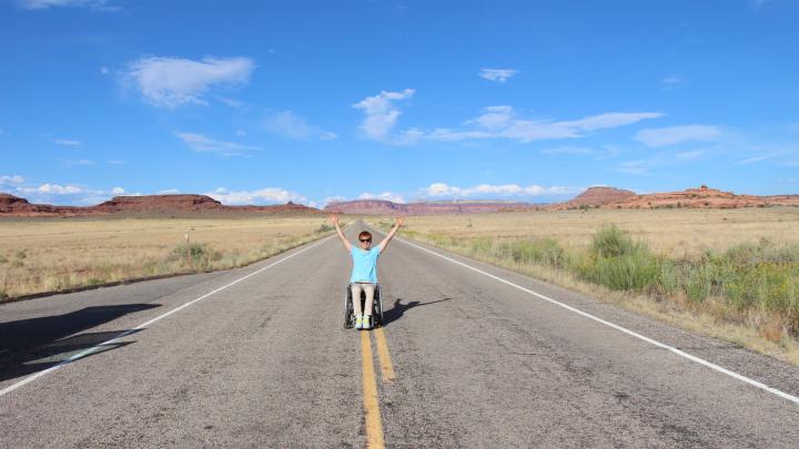 Kunho Kim celebrating on a deserted road in Canyonlands National Park, Utah