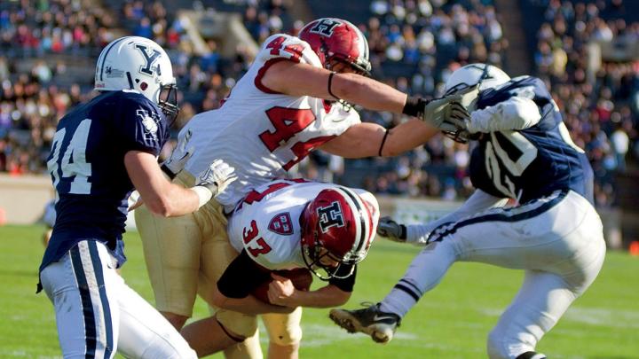 The Murphy effect: Having eschewed an easy field goal, Harvard placekicker David Mothander (37) carried out the fake called by his coach and crashed over the goal line for a momentum-building touchdown against Yale in 2011.