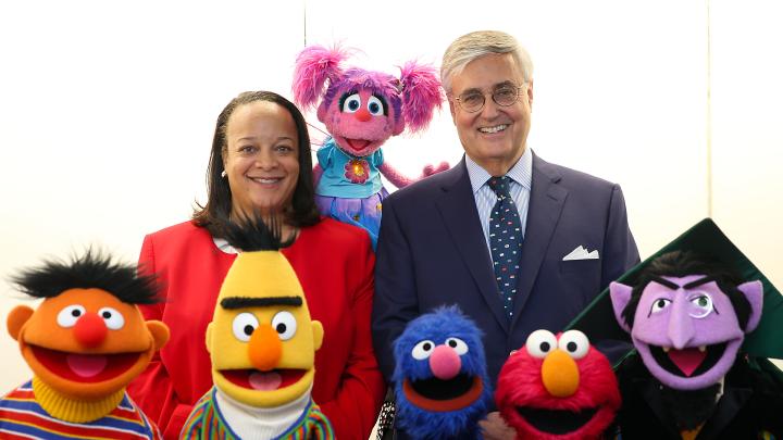 Harvard education dean Bridget Terry Long and Sesame Workshop CEO Jeffrey Dunn with a group of Muppets