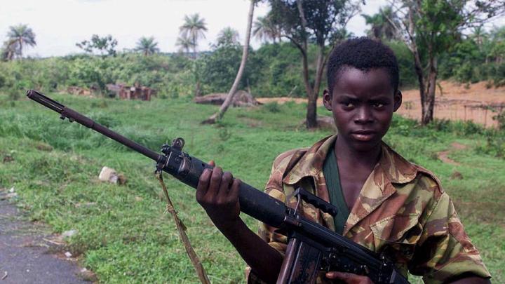 Photograph of a child soldier from Sierra Leone holding a self-loading rifle