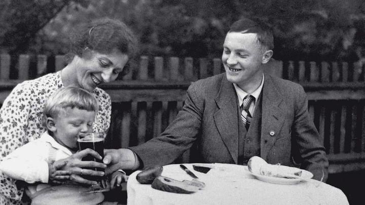 Black-and-white photograph of Karl Puchner in 1937 with his wife, young son, and a tiny, barely visible swastika button on his jacket