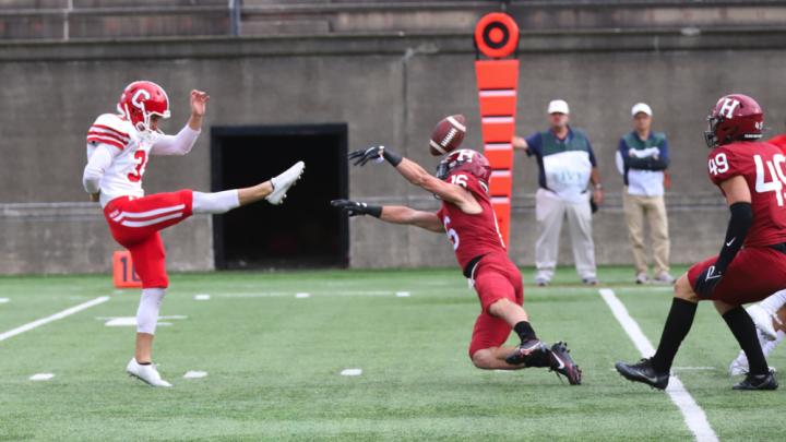  Harvard junior safety James Herring gets a hand on the punt of Cornell's Koby Kiefer.