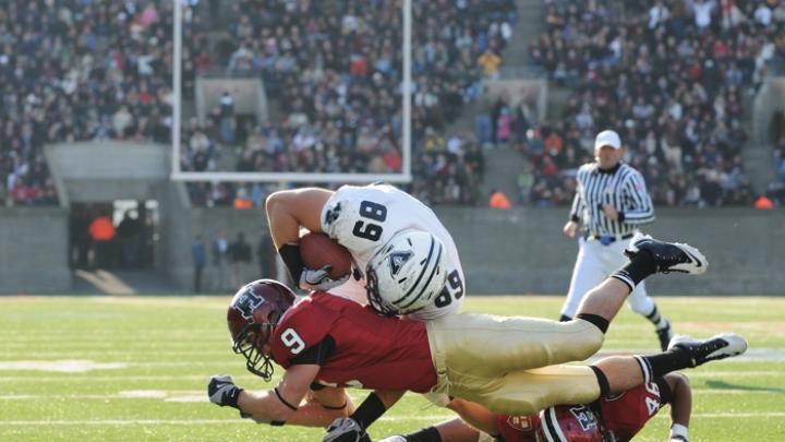 Cornerback Dan Minamide ’12 (9) and linebacker Alexander Norman ’13 (46) cut down end Chris Blohm after a three-yard pass reception in the second quarter.