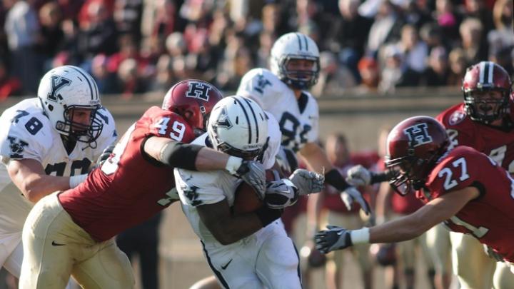 Linebacker Alex Gedeon ’12, who will captain the 2011 squad, was credited with seven solo tackles and 10 assists against Yale. Above: with Collin Zych closing in, Gedeon (49) stops halfback Cargill after a first-half gain of four yards.