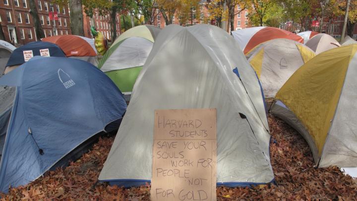 A protester's sign outside of a tent.