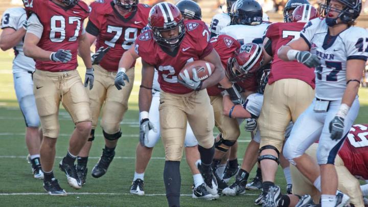 Junior tailback Treavor Scales was Harvard's top ground-gainer against Pennsylvania. His 70 yards rushing included a 35-yard breakaway, setting up a two-yard touchdown run (above) at the start of the final quarter. The Penn defender is linebacker Erik Rask.