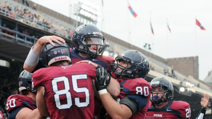 Penn players celebrate after a second-period touchdown reception by tight end Ryan O'Malley (85). Tailback Lyle Marsh (26) was the game's leading ground-gainer, with 130 yards rushing.