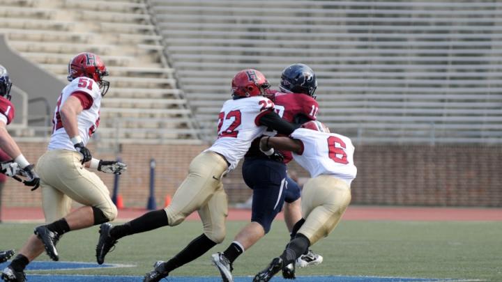 Linebacker Jacob Lindsey (51) trails the play as safety Reynaldo Kirton (22) and cornerback Brian Owusu (6) bring down Penn quarterback Billy Ragone. Ragone rushed for 95 yards and a touchdown, passing for two more Quaker scores in a 30-21 upset.