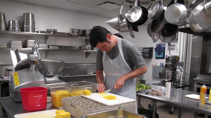 Last Friday, Pierre Hermé’s team of pastry chefs flew from France and set up shop in a Harvard kitchen, where they created four desserts that were served to the audience during the pastry chef’s lecture at the Graduate School of Design. Above, Peter Unger, a local chef who volunteered for the event, chops fruit for one of the desserts.