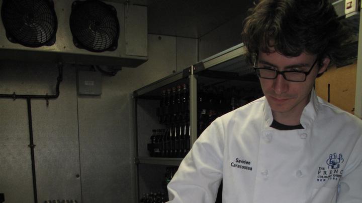 Savinien Caracostea displays a tray of macarons created in the Harvard kitchen.