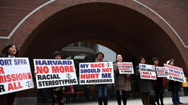 Photograph of demonstrators in front of the federal courthouse in Boston where the SFFA v. Harvard trial took place, with signs reading "Harvard No More Racial Stereotyping" and "My Race Should Not Hurt Me In Admissions.