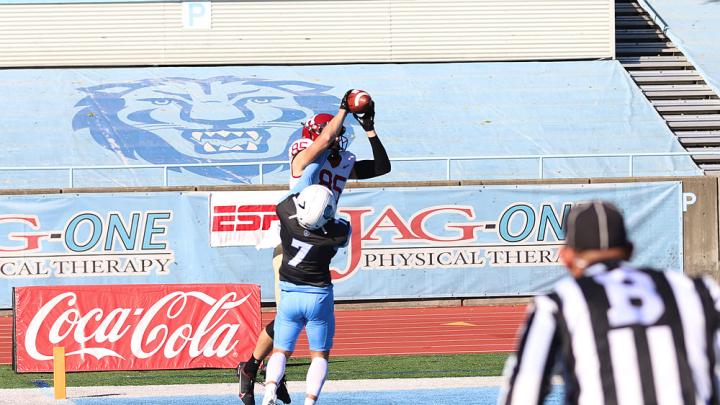 Receiver Adam West makes a leaping catch over a Columbia defender.