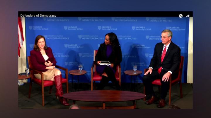The three speakers are seated on stage at Harvard's JFK Forum.