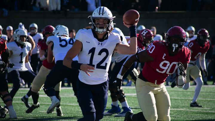 Yale quarterback Nolan Grooms being pursued; he ran for 63 yards and threw for 144.