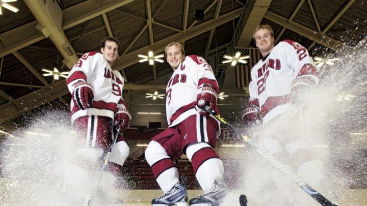 Hard-skating brothers Danny, Alex, and Michael Biega (left to right) spray ice chips at Bright Hockey Center.