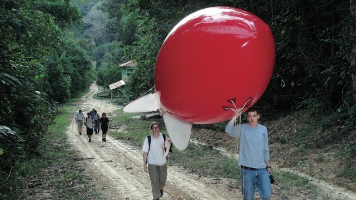 Newell and Horowitz walk the weather balloon to the launch site