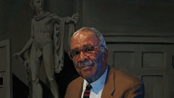 Chester M. Pierce, professor of education and psychiatry emeritus, lecturing in the Ether Dome at Massachusetts General Hospital.  Apollo stands behind him.