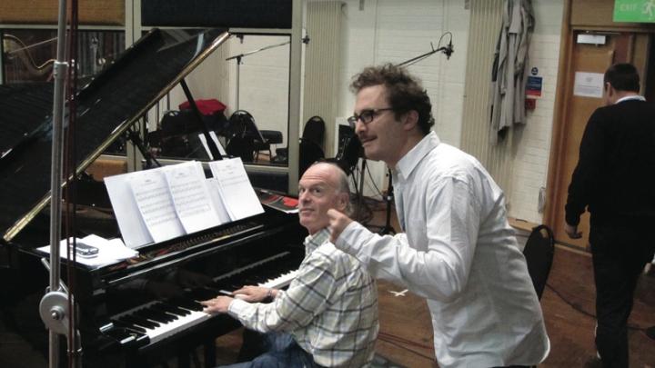 Fox Music president Robert Kraft, at the piano, works with film director Darren Aronofsky. 
