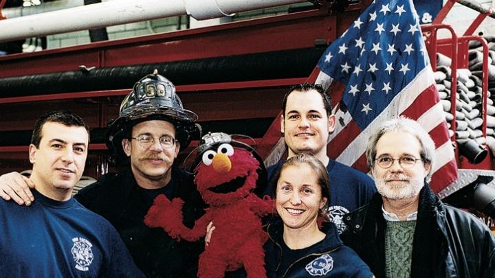 Four New York firefighters with John Weidman and <i>Sesame Street</i> character Elmo in 2001. 