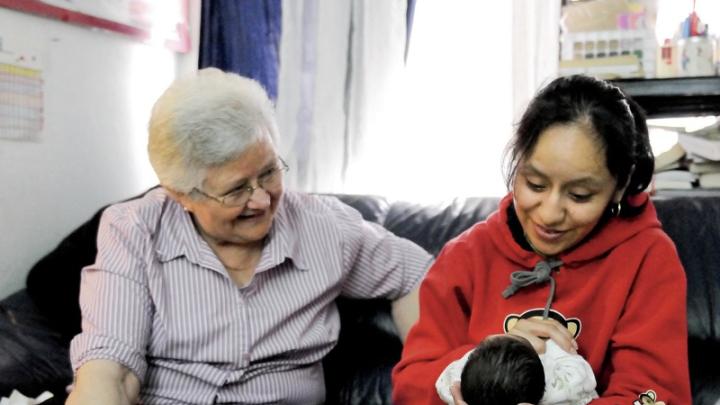 In East Harlem, Susana Saldivar and her son Xavier receive a visit from Sister Suzanne Deliee, a nurse with Little Sisters of the Assumption Family Health Service.