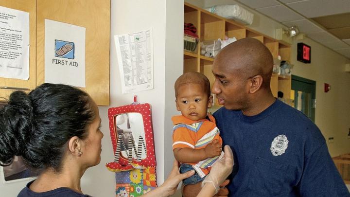 In Dorchester, Amos Monteiro leaves his son, Desmond, with teacher Stella Ortiz.