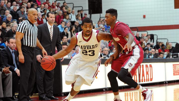 Senior Wesley Saunders (shown here, driving to the basket) led Harvard to victory with a game-high 27 points.