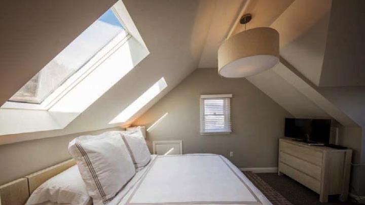 Sunlight flows into a Warfield House Inn bedroom